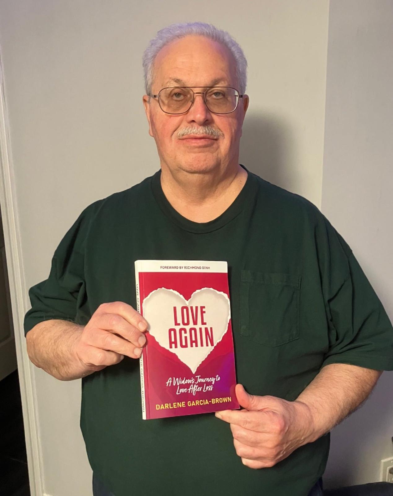 Widow holding Love Again book